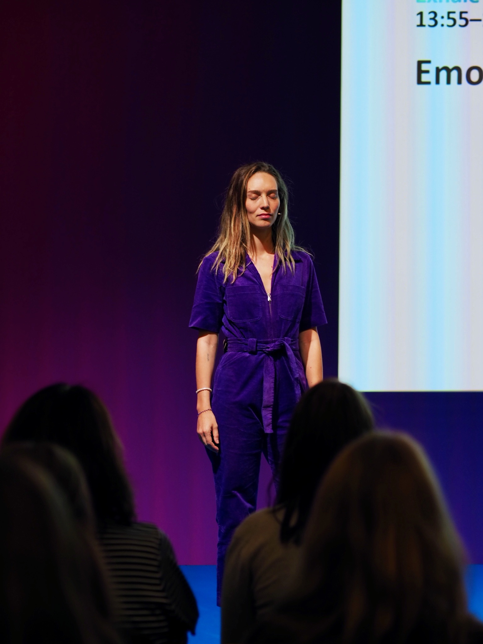 Sophie Bachmann leading a guided moment on stage